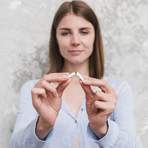 portrait young woman breaking cigarette scaled